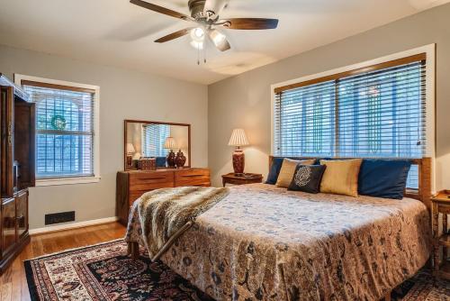 a bedroom with a bed and a ceiling fan at Exquisite 3x2 W Pool Oasis Near City Center in Houston