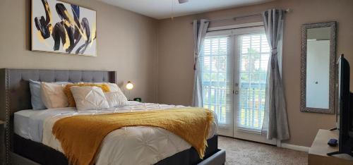 a bedroom with a bed and a large window at Pelican Bay-galveston's Hideaway in Galveston