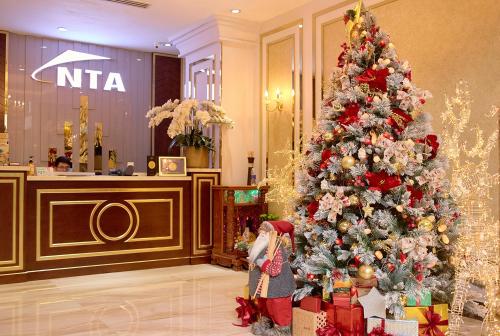 a christmas tree in the lobby of a hotel at NTA Serviced Apartments in Ho Chi Minh City