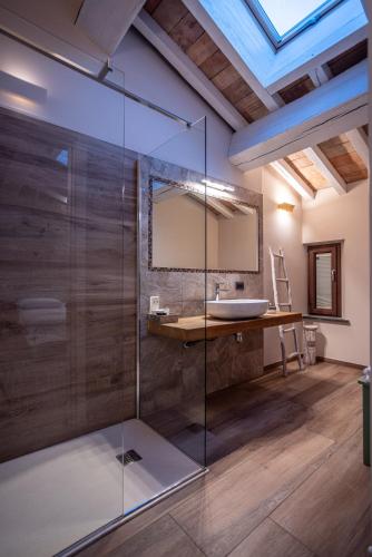 a bathroom with a glass shower and a sink at Agriturismo La Ratta in Vernasca