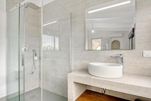 a bathroom with a sink and a glass shower at Ericito in Denia