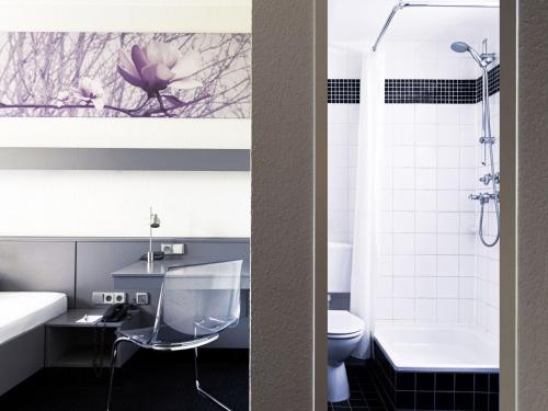 two photos of a bathroom with a sink and a toilet at Good Morning Berlin City West in Berlin