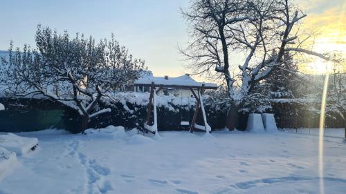 a gazebo in a yard covered in snow at Apartmán Malá Valaška in Ratiboř