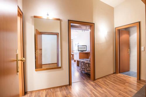 a hallway with two doors and a mirror at Hotel Landskron in Bruck an der Mur