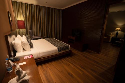 a hotel room with a bed and a desk at MONTANA VISTA in Siliguri
