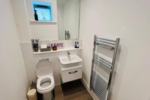 a small bathroom with a toilet and a sink at A house designed for you… in Edmonton