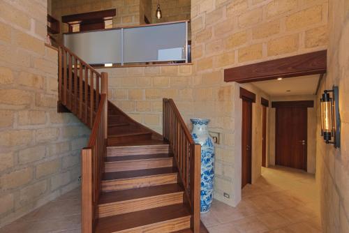 a staircase with a wall mounted flat screen tv at Tokongawa Retreat in Kaiteriteri