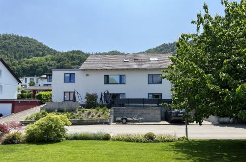 ボートマン・ルートヴィヒスハーフェンにあるFerienwohnungen AVIVA Bodman - Urlaub in unmittelbarer Seenäheの車寄せの白い家