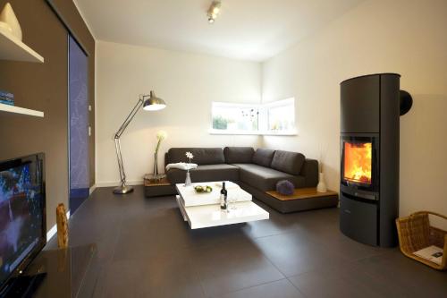a living room with a couch and a fireplace at Lotsenstieg 05 in Karlshagen
