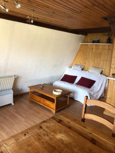 a bedroom with a bed and a coffee table at Les Jonquilles in Les Angles