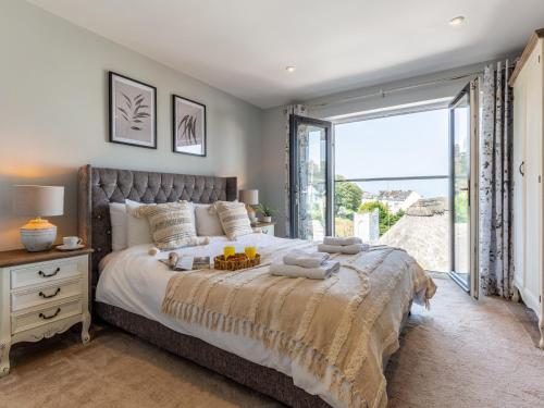 a bedroom with a large bed and a large window at 3 Bed in Ilfracombe 48133 in Ilfracombe
