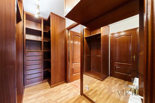 a walk in closet with wooden doors and wooden floors at Can Noguer Chalet de Lujo en Escaldes ,vistas panorámicas, jacuzzi in Escaldes-Engordany