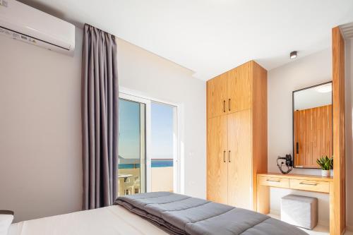 a bedroom with a bed and a desk and a mirror at Falasarna Bay in Falasarna