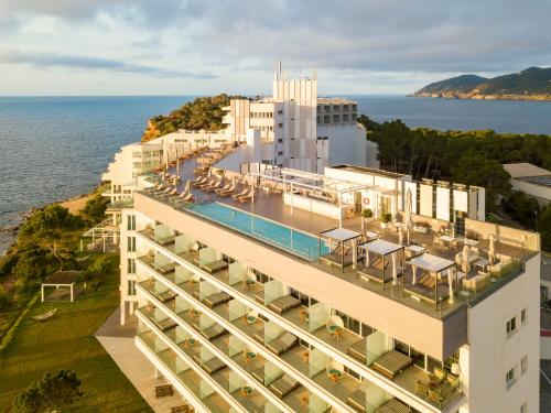 an aerial view of a hotel with the ocean in the background at Melia Ibiza - Adults Only in Santa Eularia des Riu