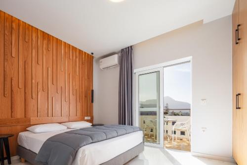 a bedroom with a bed and a large window at Falasarna Bay in Falasarna