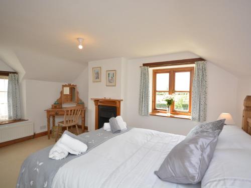 a bedroom with a large white bed and a window at 2 Bed in Wedmore 53989 in Wedmore