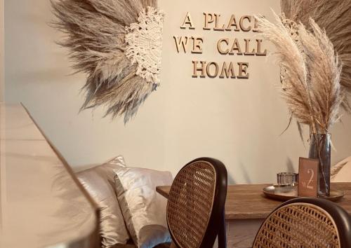 a room with two chairs and a table with feathers on the wall at Heart Ferienwohnungen in Vogtsburg