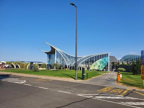 a large glass building with a road in front of it at BioLocalia House Dobrogea in Baloteşti