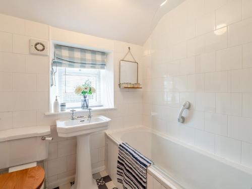 a white bathroom with a sink and a bath tub at 2 Bed in York 64455 in Sheriff Hutton