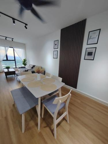 a white table and chairs in a living room at ORPHIC Homestay @ Bandar Country Homes, Rawang in Rawang