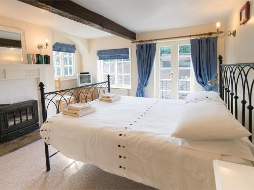 a bedroom with a large white bed and a fireplace at 4 bed property in Knaresborough HH090 in Knaresborough