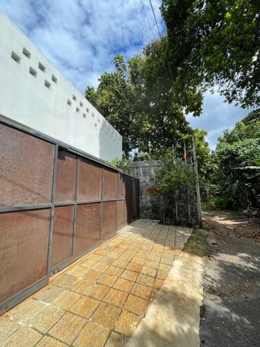 a building with a gate and a brick wall at AJ Villa in Negombo