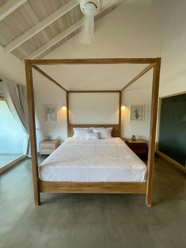 a bedroom with a canopy bed and two night stands at AJ Villa in Negombo
