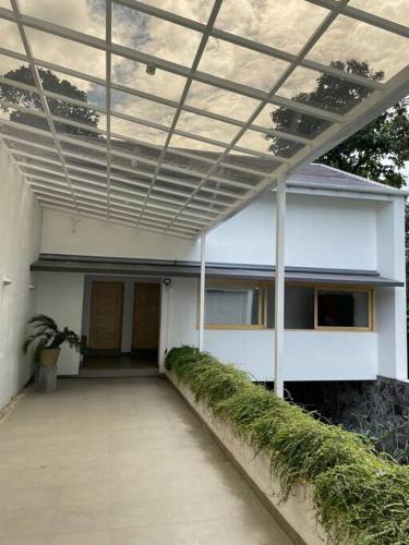 a white building with awning on the side of it at AJ Villa in Negombo