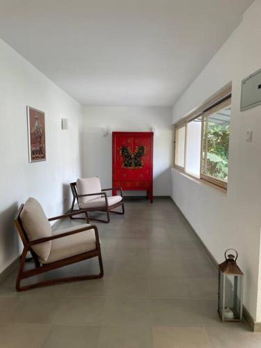 a living room with two chairs and a window at AJ Villa in Negombo