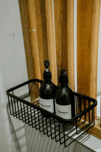 a black basket with two bottles on a shelf at Bingin Garden Uluwatu in Uluwatu