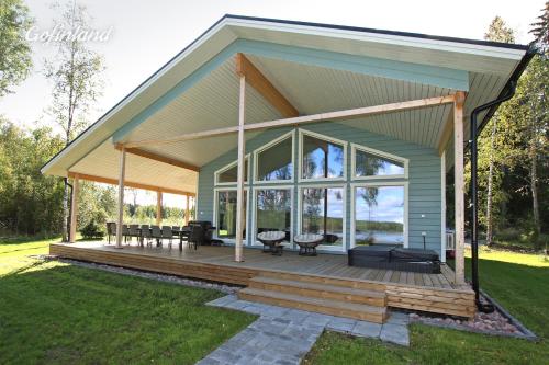 a screened in porch with furniture and windows at villa julia in Tampere