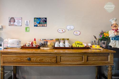 a wooden table with food on top of it at The Guest Hotel Krabi in Krabi town