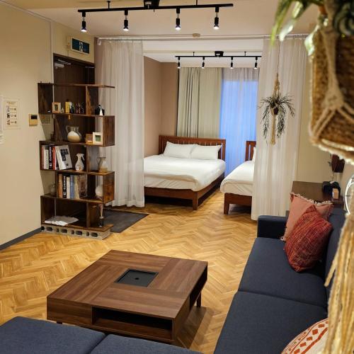 a living room with a couch and a bed at supiahouse in Tokyo