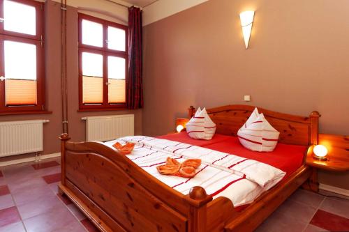 a bedroom with a bed with red and white pillows at Villa Maria Wohnung 03 in Ostseebad Koserow