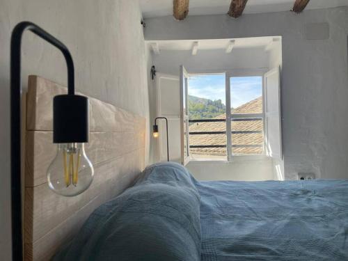 a bedroom with a bed and a window at La casita de la fuente in Cazorla