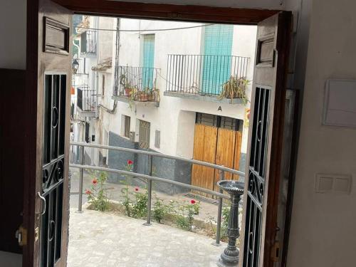 a view of a balcony from an open window at La casita de la fuente in Cazorla