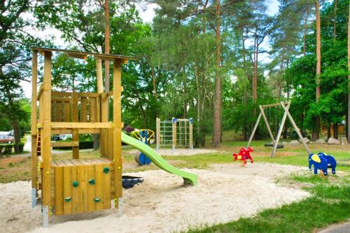 a playground with a slide in a park at Camping Aller Leine Tal in Engehausen