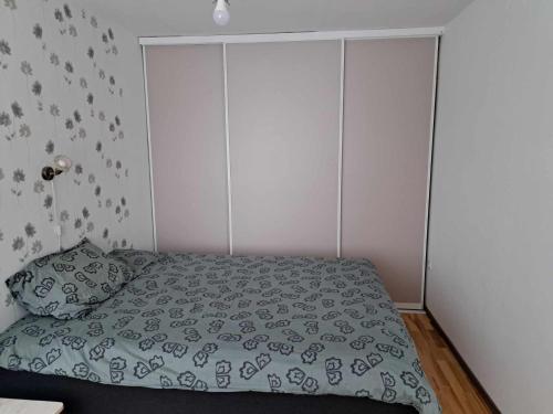1 dormitorio con 1 cama con edredón verde en Räpina, en Räpina