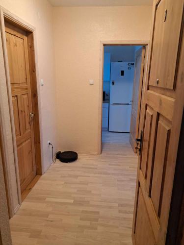 a hallway with a door and a kitchen with a refrigerator at Räpina in Räpina