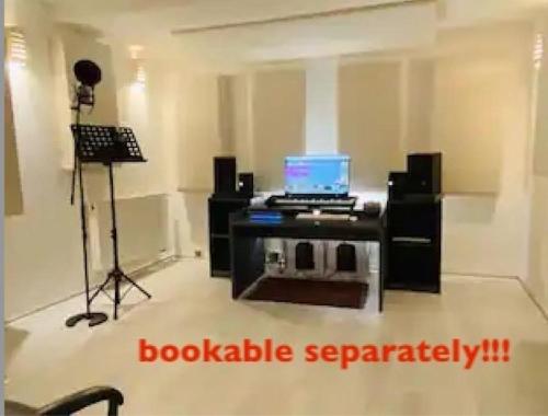 a room with a desk with a laptop and a camera at urban-studios-cologne I studio in Cologne