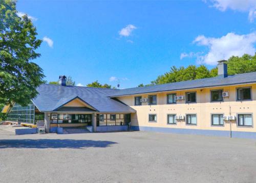 a large white building with a large parking lot at Berjaya Hakkoda Ski Resort in Aomori