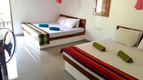 two beds in a room with two beds sidx sidx sidx at Hotel 4u Udawalawe in Udawalawe