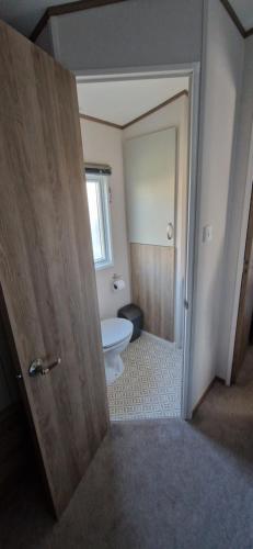 an open door to a bathroom with a toilet at D4 Dove Close in Goodrington