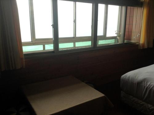a bedroom with a bed and a window at Bunbury Fruit Ranch B&B in Renai