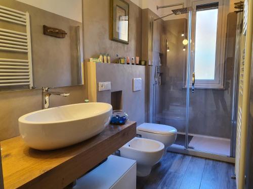 a bathroom with a large sink and a toilet and a shower at Guest House Baia dei Sogni in Rapallo