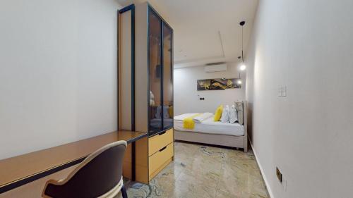 a room with a bedroom with a bed and a mirror at YANNA APARTMENT BY KHALIQUES in Abuja