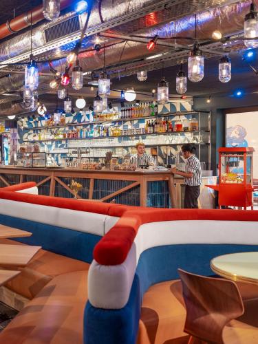 a restaurant with a red white and blue bar at Eklo Montpellier Centre Gare in Montpellier