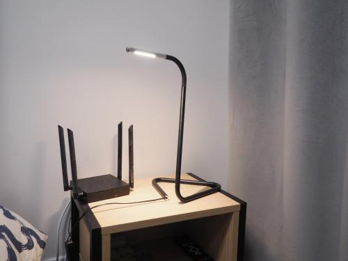 a desk with a lamp and two computer monitors on it at Twój dom in Warsaw