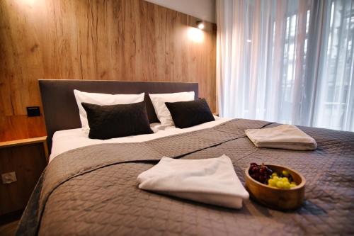 a bedroom with a large bed with a bowl of fruit on it at Laguna Beskidów Forest 22 & 23 in Zarzecze
