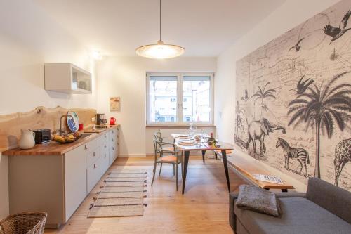 a kitchen with a table and a dining room at Juliusliving - modernes Wohnen an der Juliuspromenade in Würzburg